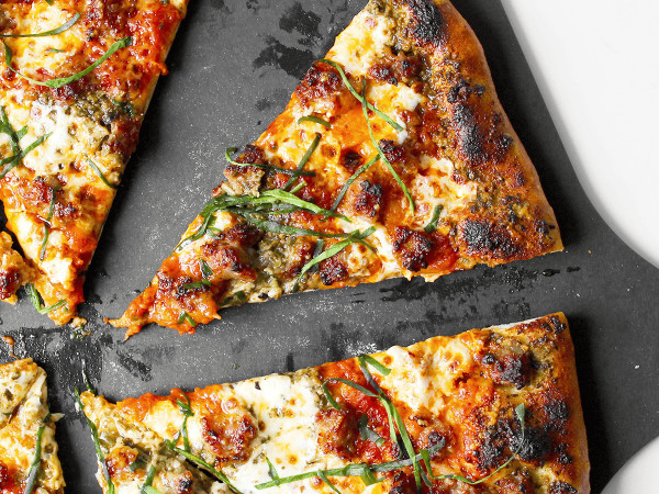 Margherita Pizza Topped with Sausage and Pesto