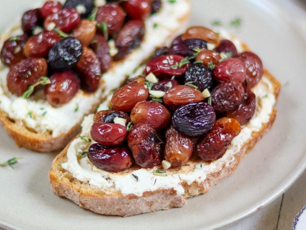 Toasted Bread with Roasted Grapes and Herb Garnish