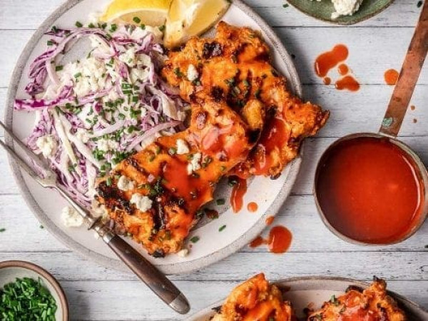 Blue Cheese Slaw Accompanied by Grilled Buffalo Chicken Thighs